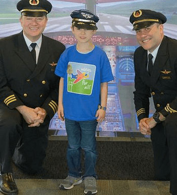 Pictured: A young boy with two pilots during the Wings for All event in Wisconsin.