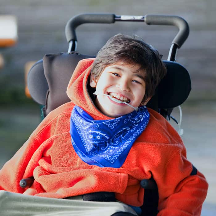 needs-are-met-for-life-1 Young boy wearing a mouth brace in a wheelchair